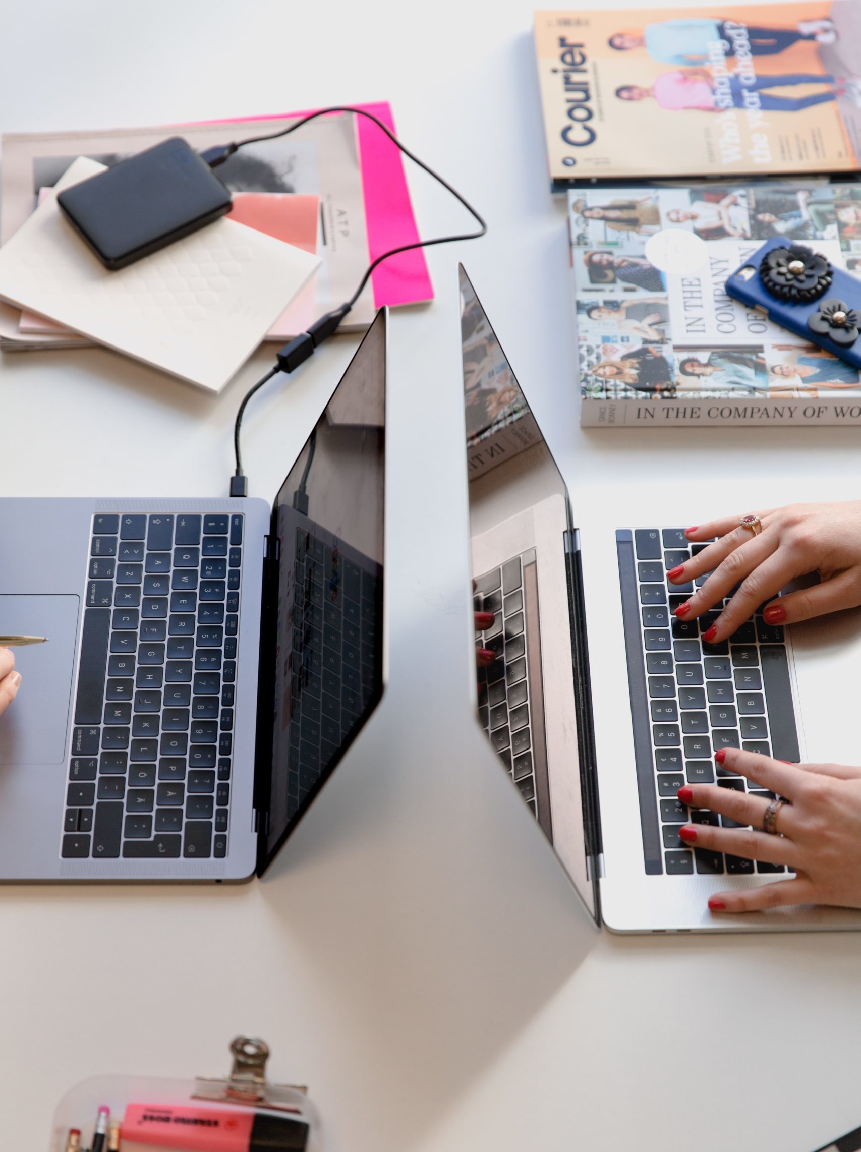 two laptops being used on a desk