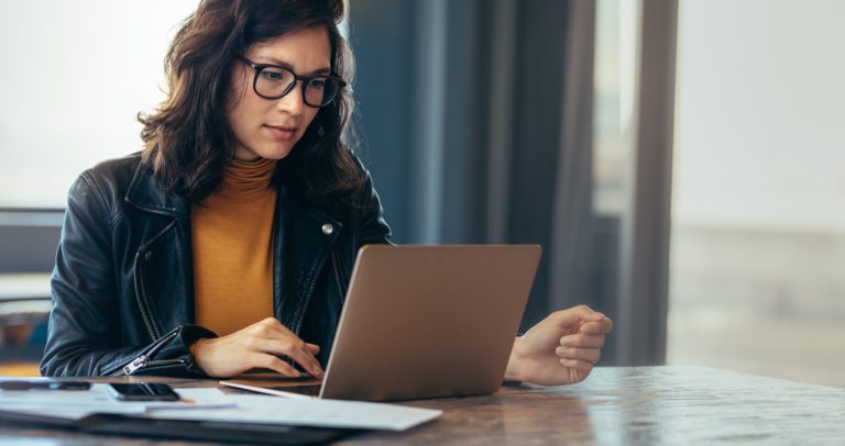 A person looking down at their laptop.